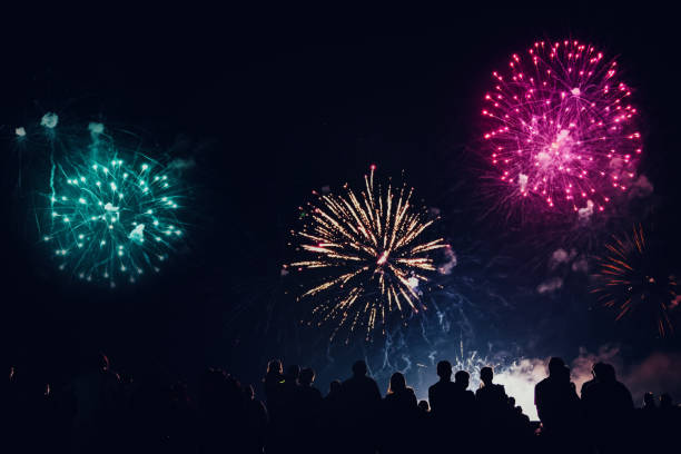 istock Crowd watching fireworks and celebrating new year eve 1083678834
