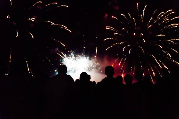 istock Crowd watching fireworks and celebrating new year eve 1083679910