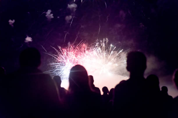 istock Crowd watching fireworks and celebrating new year eve 1083679916