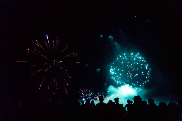 istock Crowd watching fireworks and celebrating new year eve 1083679952