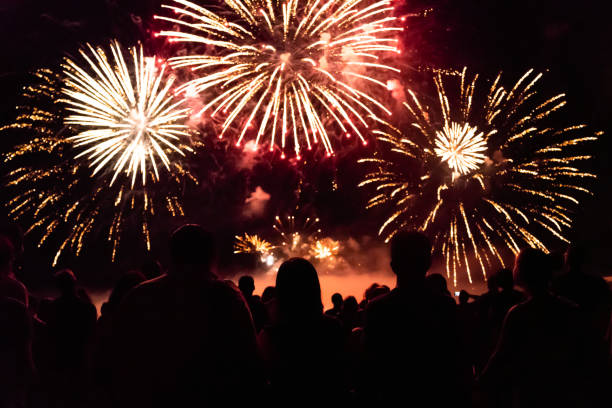 istock Crowd watching fireworks and celebrating new year eve 1083679958