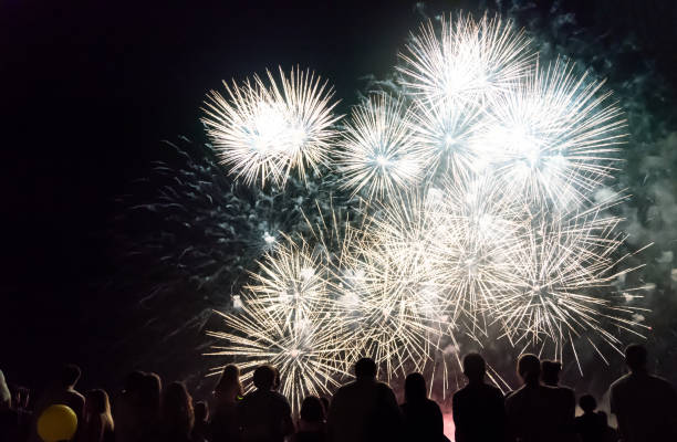 istock Crowd watching fireworks and celebrating new year eve 1083680102