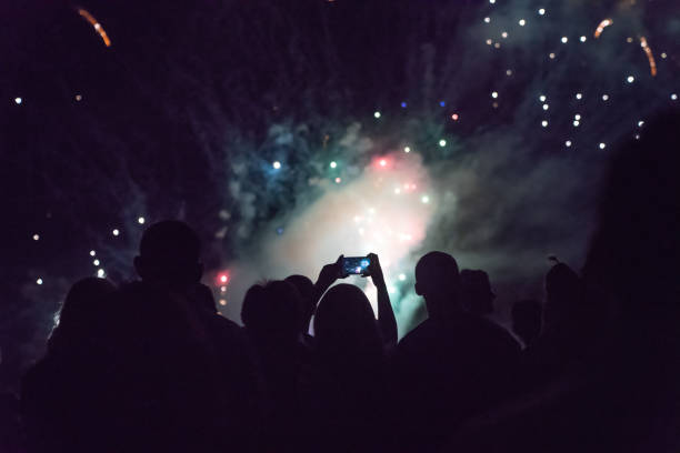 istock Crowd watching fireworks and celebrating new year eve 1083680114