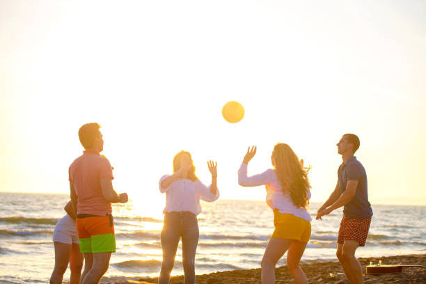 istock Group of young people playing volleyball on the beach 1083680792