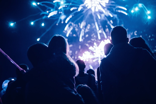 Crowd watching fireworks and celebrating at night