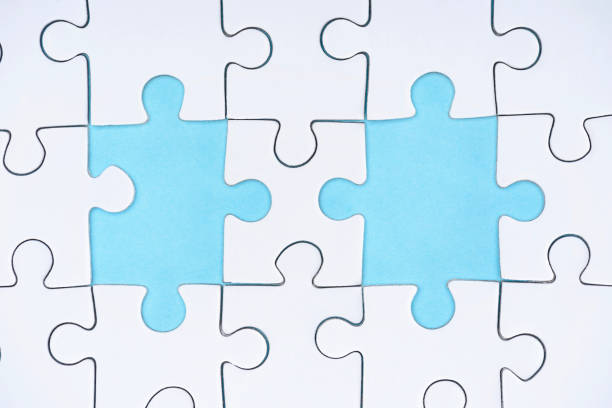 istock flat lay with white puzzle pieces on blue background 1083684234