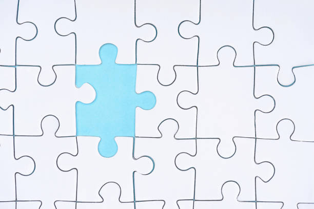 istock flat lay with white puzzle pieces on blue background 1083684248