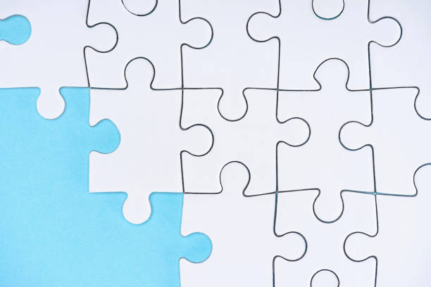 istock flat lay with white puzzle pieces on blue background 1083684254