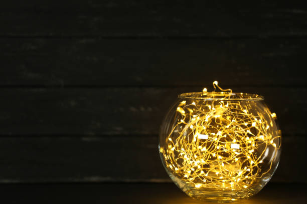 istock Garland lights in glass bowl on black background 1083687226