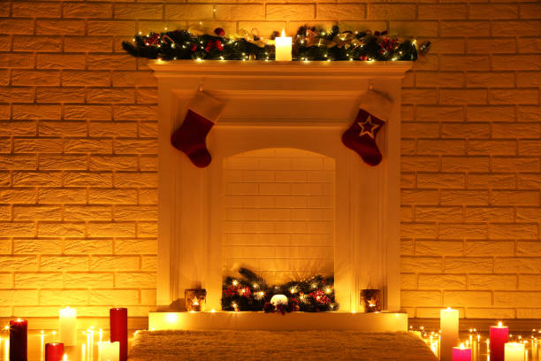 istock White decorated fireplace with candles on brick wall background 1083690040