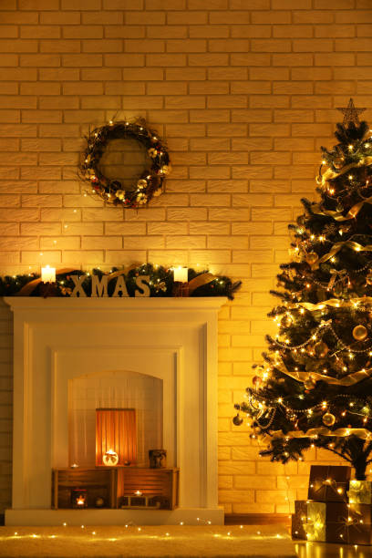 istock White decorated fireplace near christmas tree on brick wall background 1083691588