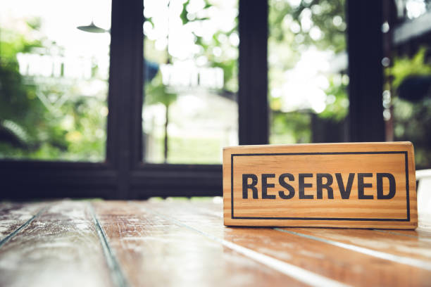 istock Reserved sign on a restaurant wooden table. 1083692120