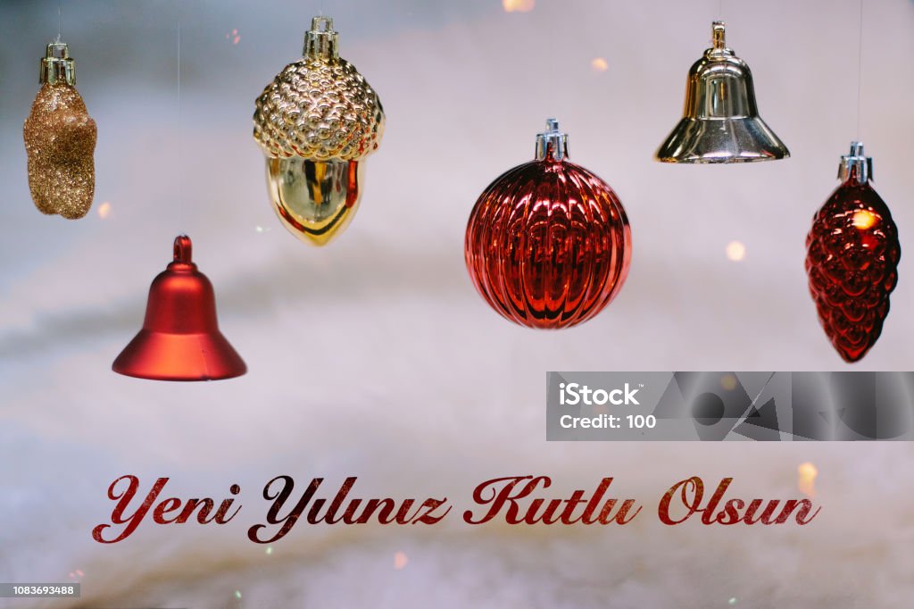 Shiny gold and red christmas balls and bells for new year. Yeni yiliniz kutlu olsun means happy new year Shiny gold and red christmas balls and bells for new year. Yeni yiliniz kutlu olsun means happy new year. Bell Stock Photo