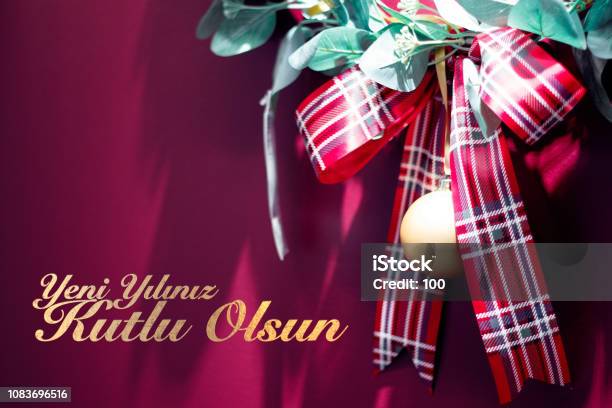 Red Christmas Gift Ribbon On Red Background With Text Yeni Yiliniz Kutlu Olsun Means Happy New Year Stock Photo - Download Image Now