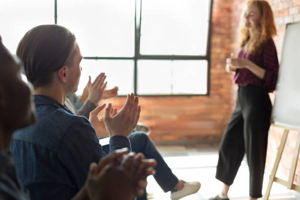istock Audience clapping hands after business seminar at loft 1083698174