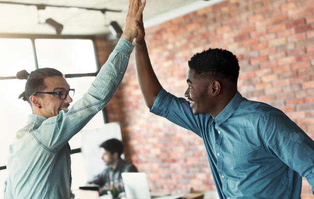 istock Happy diverse colleagues giving high five, enjoying partnership 1083699272