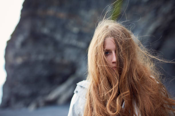 istock Beautiful, seductive woman posing on a black beach 1083699746