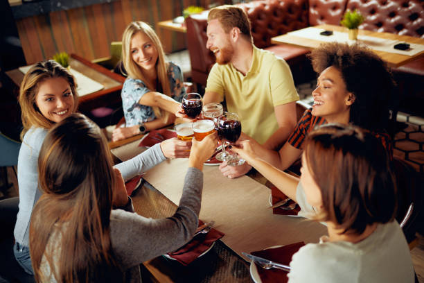 istock Friends making a toast while sitting in restaurant. 1083706640