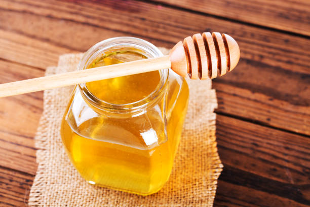istock Jar of honey and Honeycomb on Table 1083707118