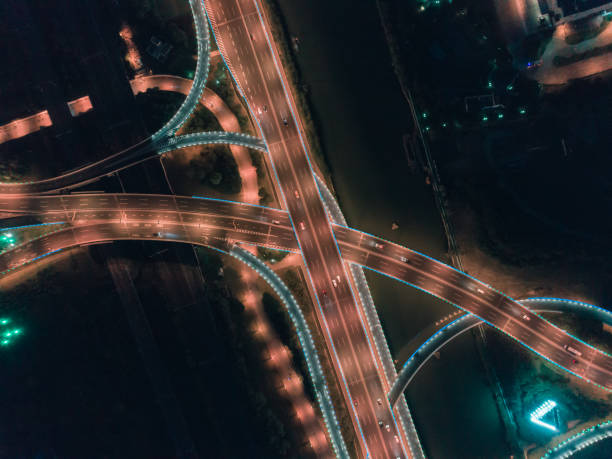 istock Aerial drone flight over night road traffic. Two-level road junction. Top view. 1083707468