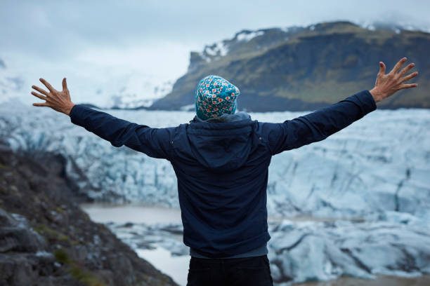 istock Tourist enjoying amazing view. Open arms on glacier lagoon 1083708172