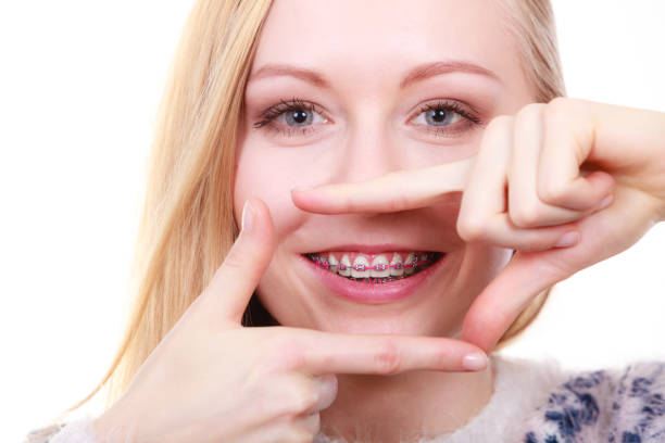 istock Happy woman showing her braces on teeth 1083711552
