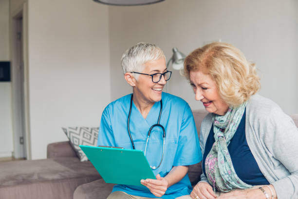 istock Nurse and patient having fun in revising paperwork 1083717908