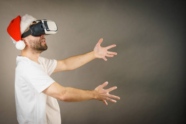 istock Man in virtual reality goggles and santa hat 1083717962