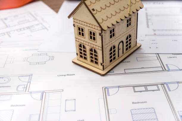 istock Wooden house model on house plan, close up 1083720178