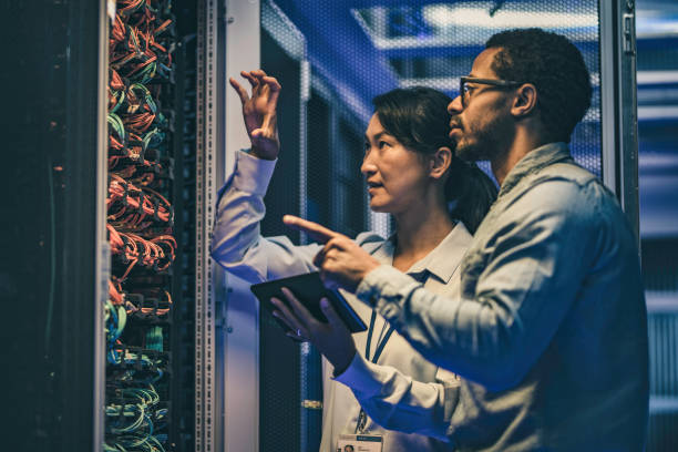 istock Female Asian IT technician explaining network connection to a novice engineer 1083723046