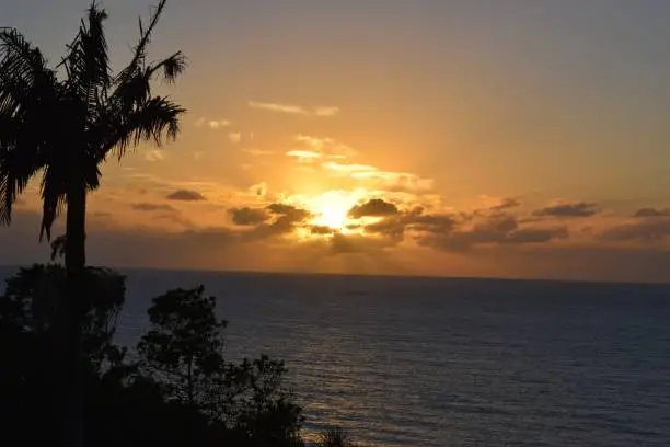 The light of the sunrise through the clouds making a spectacle in its simplicity.