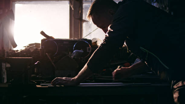 istock Male mechanic in a workshop drawing. 1083726714