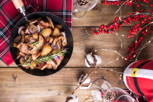 istock Assorted snacks and fried potatoes with mushrooms and meat on a wooden table. Delicious traditional winter food in Russia. Celebration of Christmas and New Year. Free space for text. 1083729882