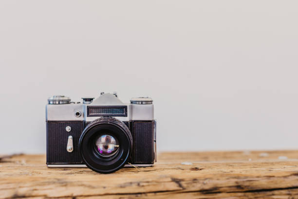 istock Vintage camera on brown wooden table, with text space 1083729910