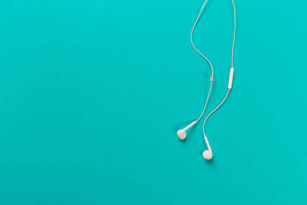 istock White earphones on menthol background 1083730114