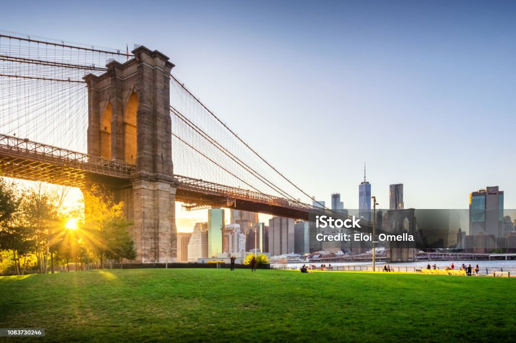 Brooklyn Bridge and Manhattan at sunset. NYC View of Brooklyn Bridge and Lower Manhattan at sunset with sun Flare and a blank space New York City Stock Photo