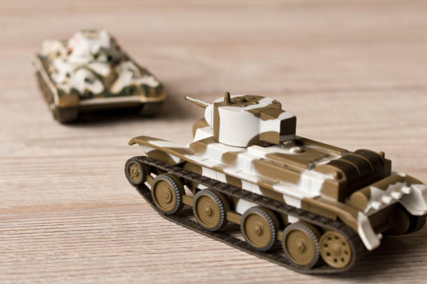 istock Toy models of Soviet tanks on a wooden table. 1083733856