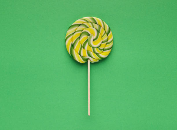 Top view on large spiral lollipop on green background