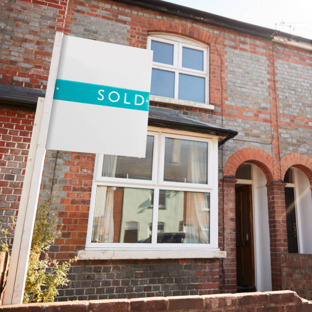 istock Real Estate Sold Board Outside Terraced House 1083736476