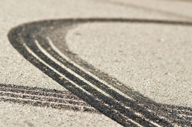 Round mark Close-up of several tire skid marks on asphalt street skid marks stock pictures, royalty-free photos & images