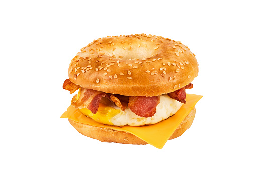 Close up on a sandwich breakfast isolated on white background. Bagel, egg, cheese and bacon.