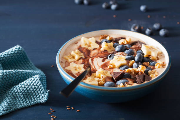 istock healthy banana smoothie bowl with blueberry chocolate walnuts 1083745508