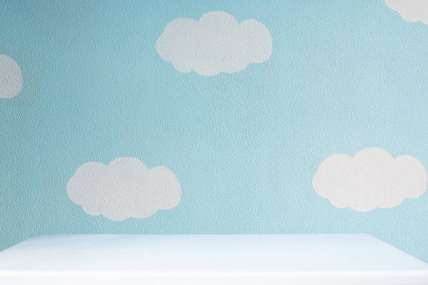 istock beautiful blue wall with clouds and empty white tabletop in cute nursery 1083751460