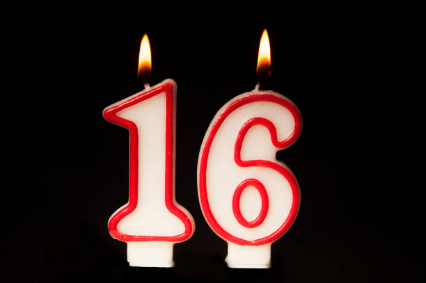 istock 16 birthday candle isolated on black 1083754914