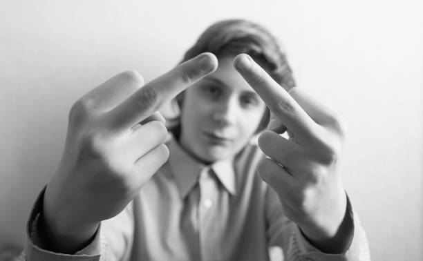 istock Teen boy shows middle finger gesture 1083757380