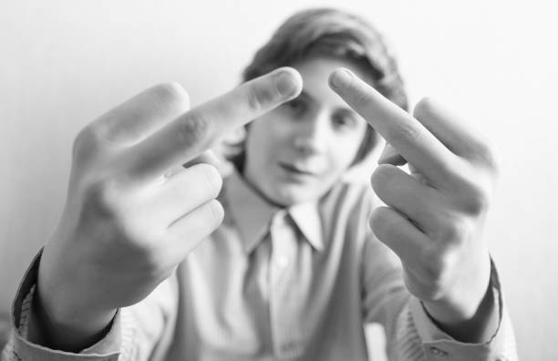 istock Teen boy shows middle finger gesture 1083757384