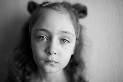 Portrait of a little girl sad and offended isolated