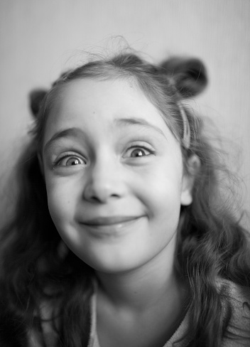 Portrait of a little girl surprised and pleased isolated