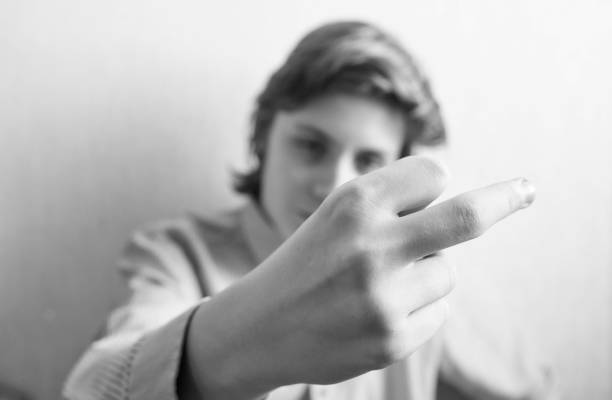 istock Teen boy shows middle finger gesture 1083758402