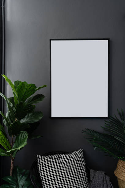 istock Compostion empty natural wooden frames setting on gray painted wall surrounded by artificial plants setting in natural lighting scene / cozy interior concept / object isolated 1083760622